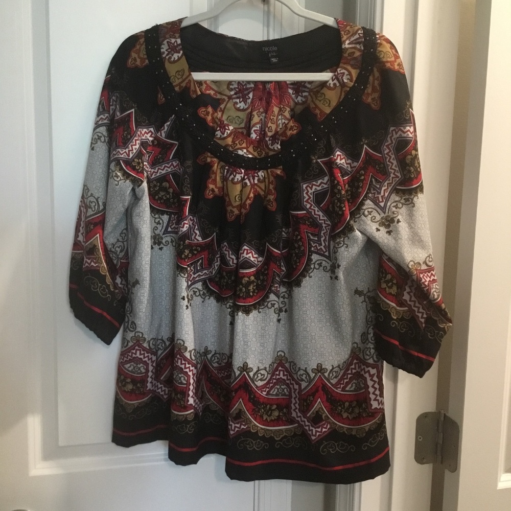Nicole top, size 14. Flattering silky fabric with beaded trim around the neckli.